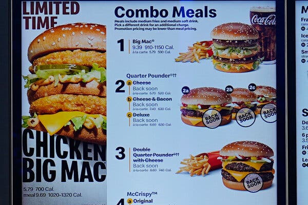 A menu board shows several burger options on a McDonald’s menu, including Quarter Pounders with lines through the lettering for each one. And beneath each choice of cheese, cheese and bacon or deluxe, the notice “Back soon” was added.