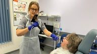 Nina Glazzard, an advanced clinical practitioner for ears, nose and throat, using an endoscope-I adapter on Janet Hennessy, 76, from Bradeley, Stoke-on-Trent, as part of a trial at North Midlands University Hospitals NHS Trust. The adapter includes a 32mm lens that attaches to an iPhone, turning it into a portable endoscope to help the NHS rule out throat cancer in patients faster. Issue date: Saturday November 2, 2024.