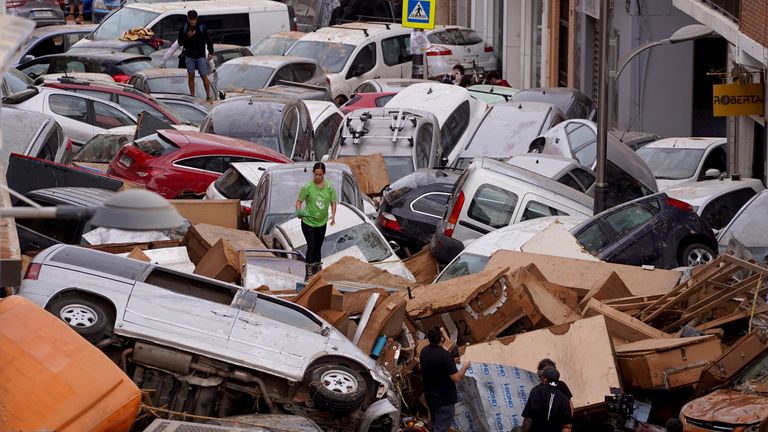 Vehicles are seen piled up after being swept away by floods in Valencia, Spain, Thursday, Oct. 31, 2024. (AP Photo/Alberto Saiz)